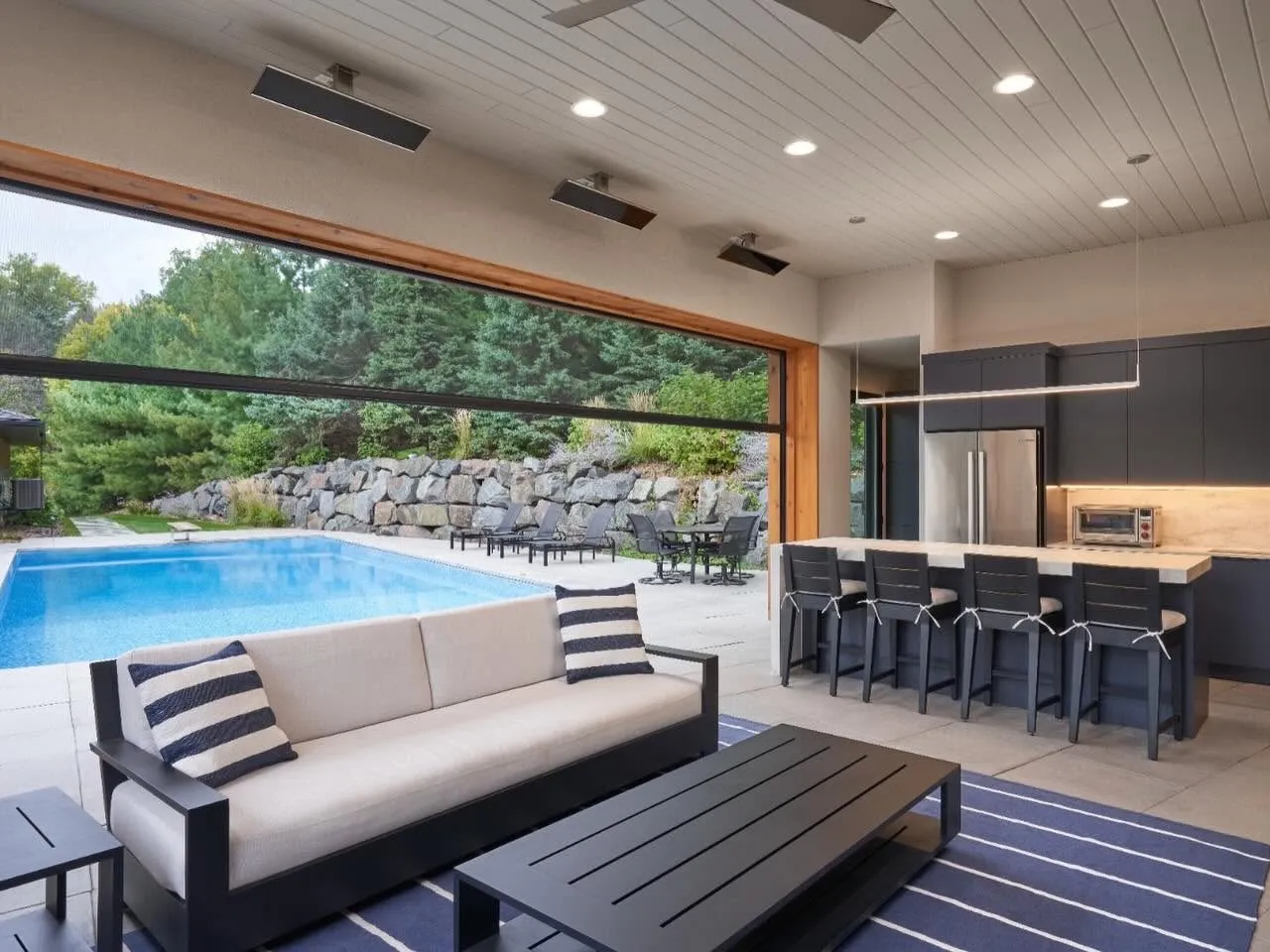 Intérieur d'un pavillon ouvert sur la piscine grâce aux toiles Phantom